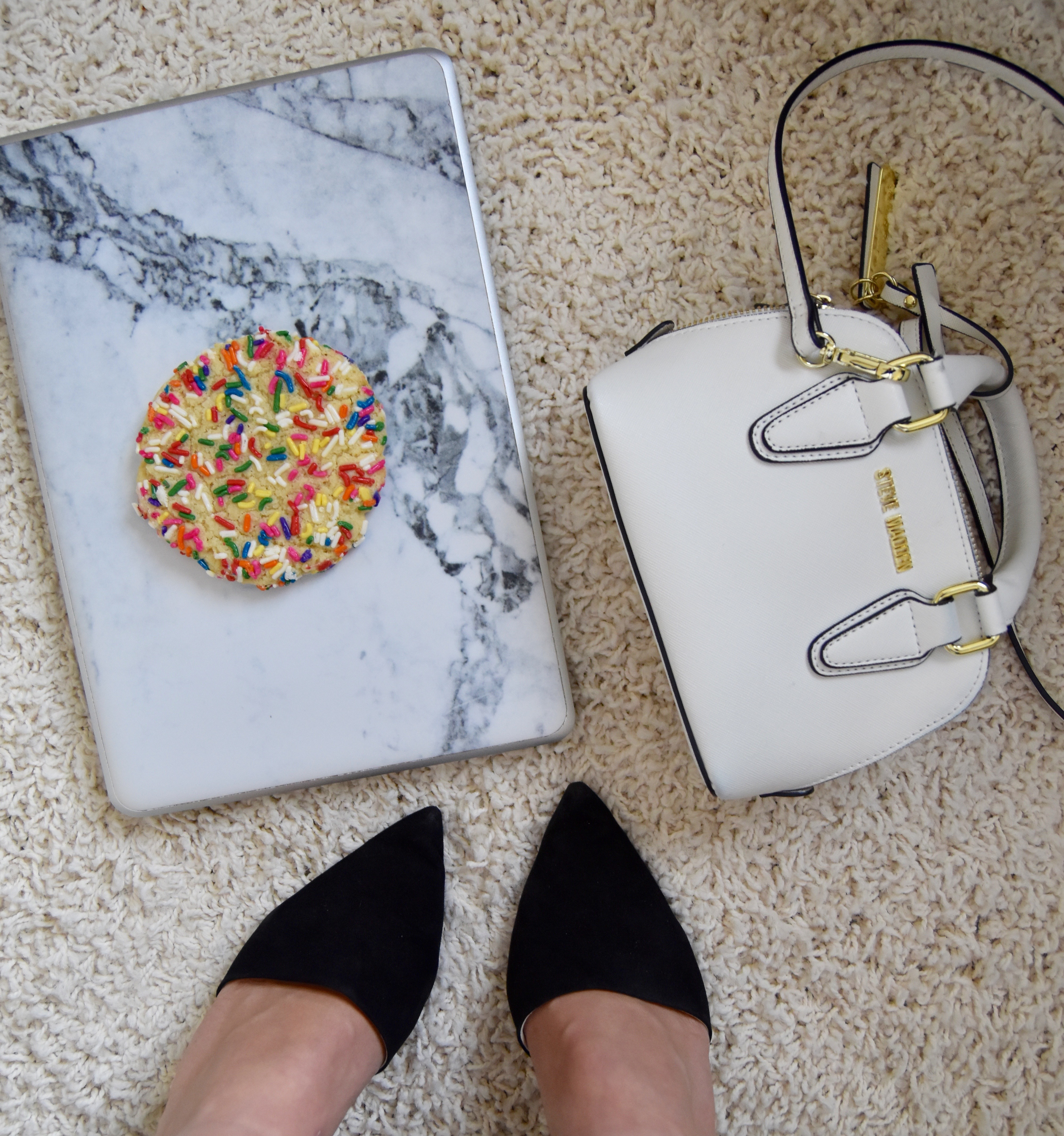 A2F Sunflour baking company sugar cookie with sprinkles with a Steve Madden mini bag and Zara heels