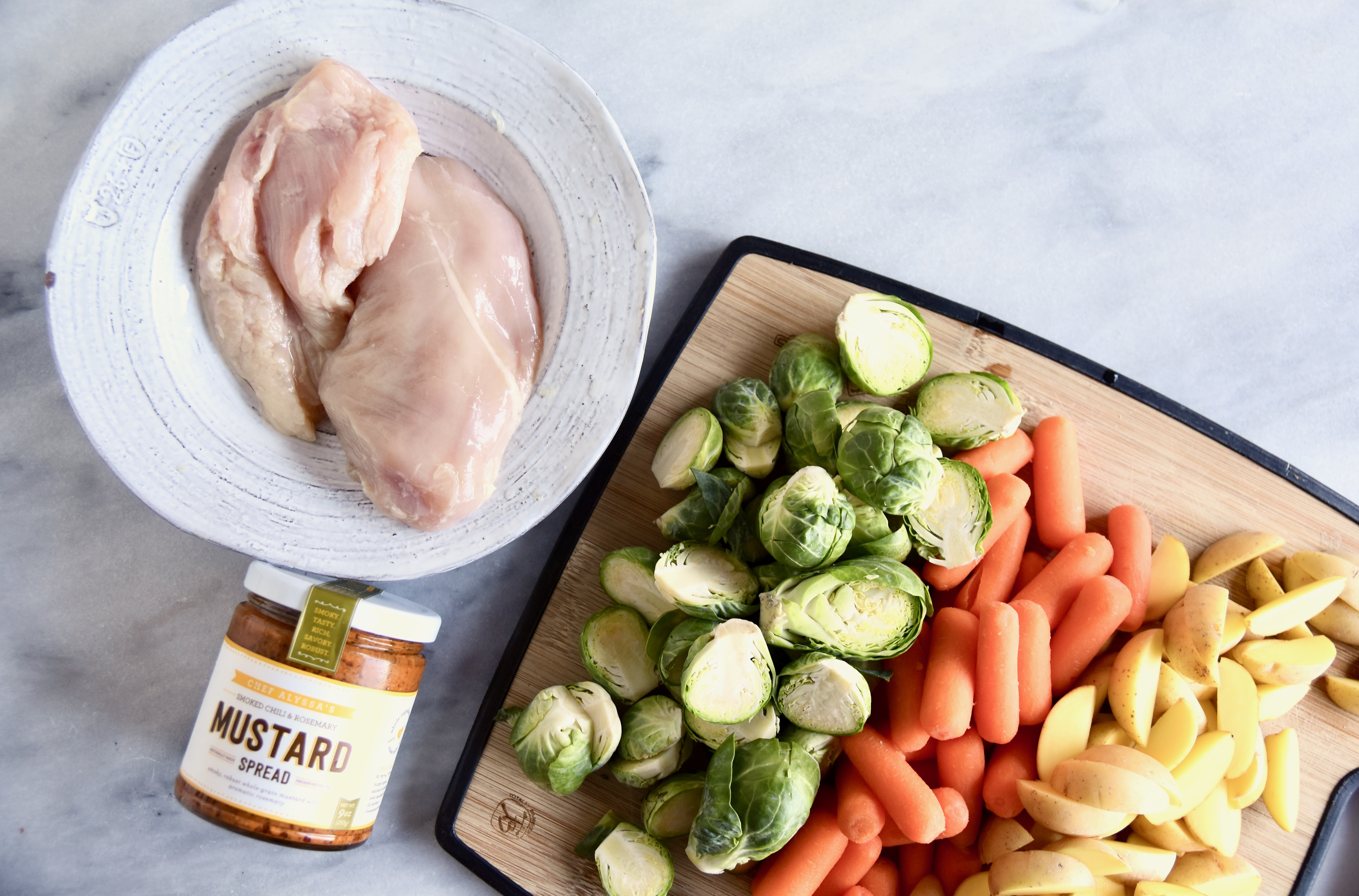 mis en place of chicken, vegetables, and Chef Alyssa mustard spread