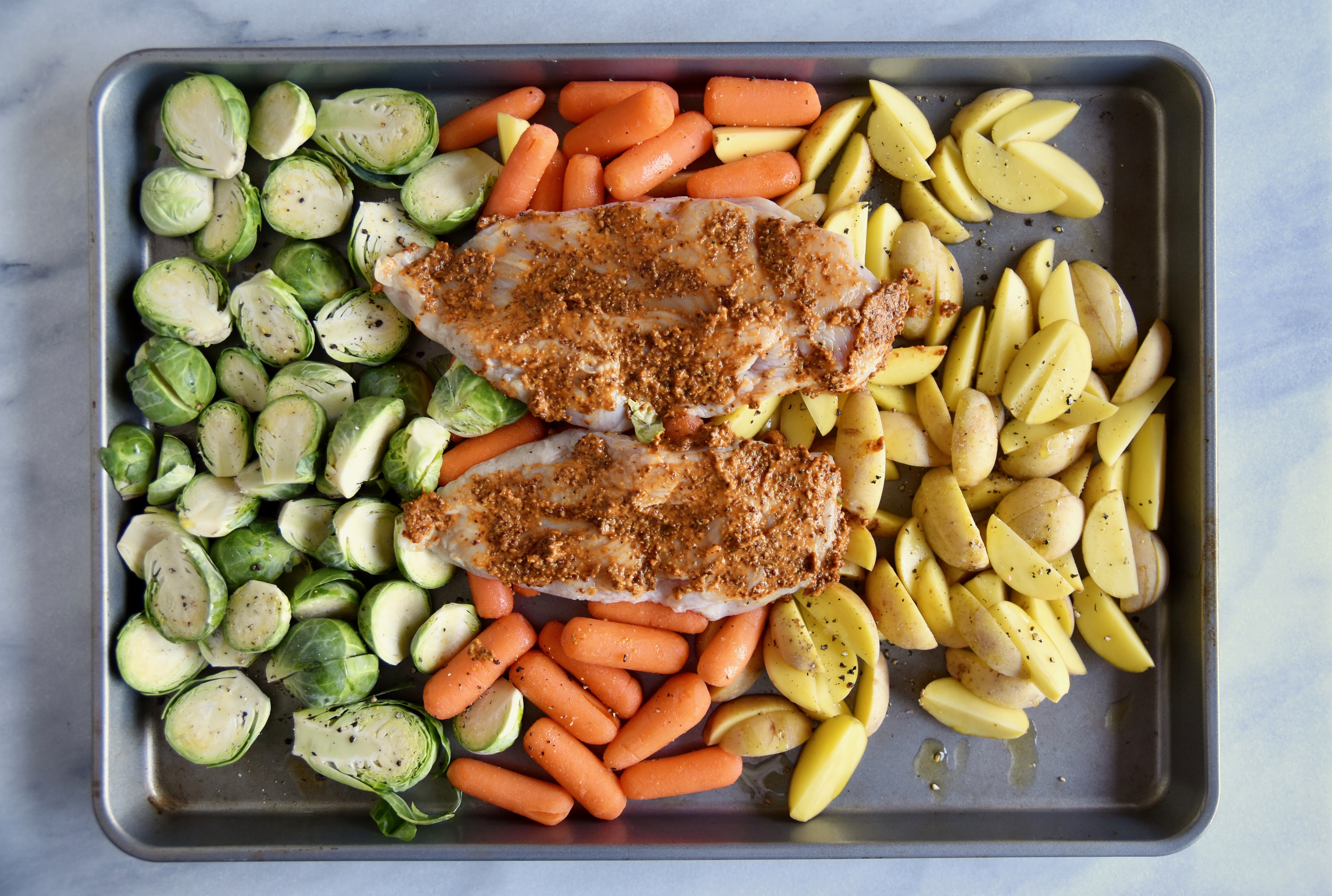 chicken with mustard marinade on top of baked vegetables