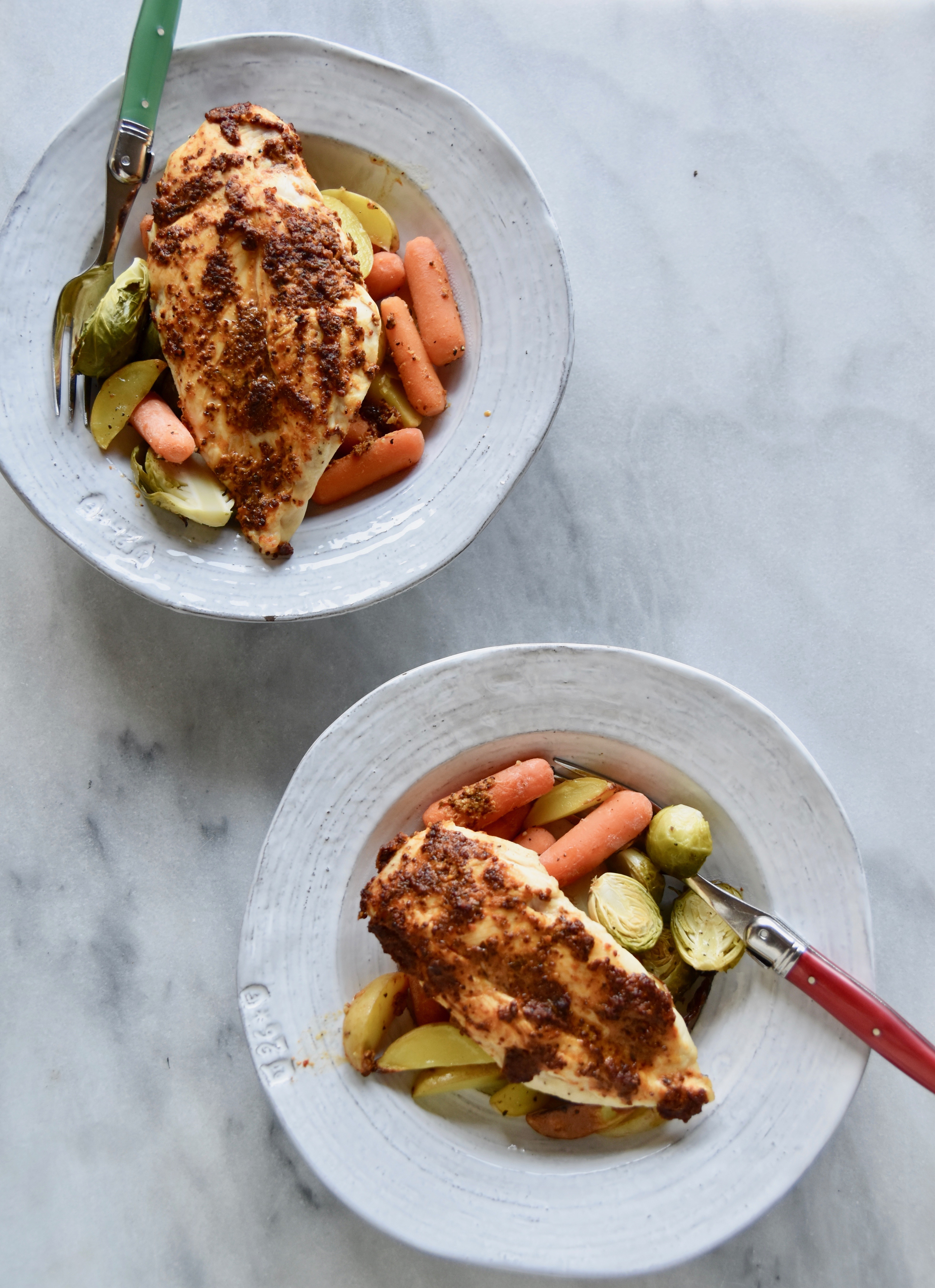 chicken and vegetables divided into plates for dinner