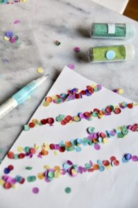 Back of Holiday gif wrap with water colors and paper confetti finished