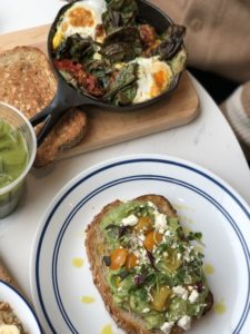 A2F flatlay of avocado smash, kale juice and baked eggs at Bluestone Lane in D.C.