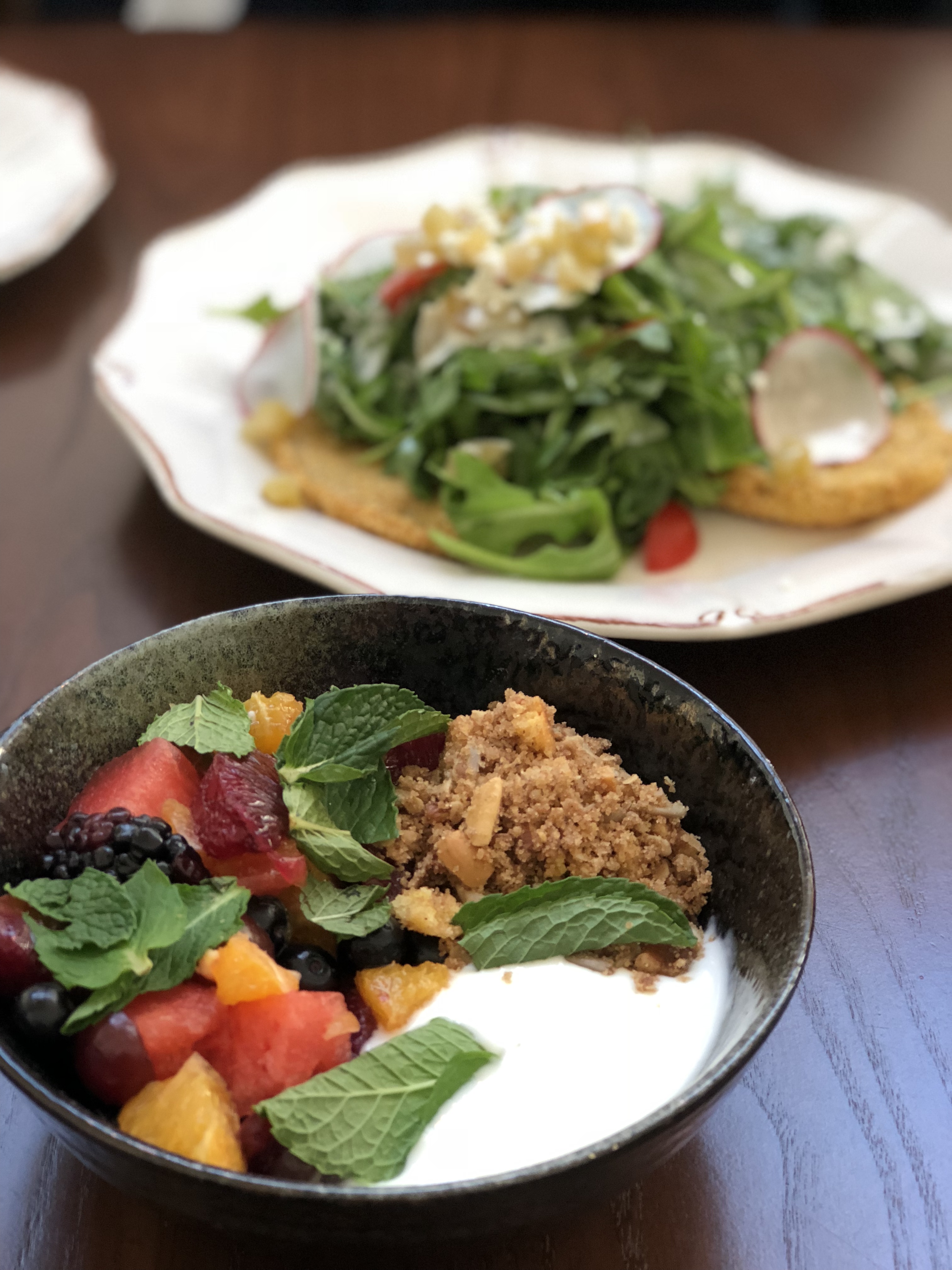 Seasonal fruit bowl and fried green tomato salad at Succotash