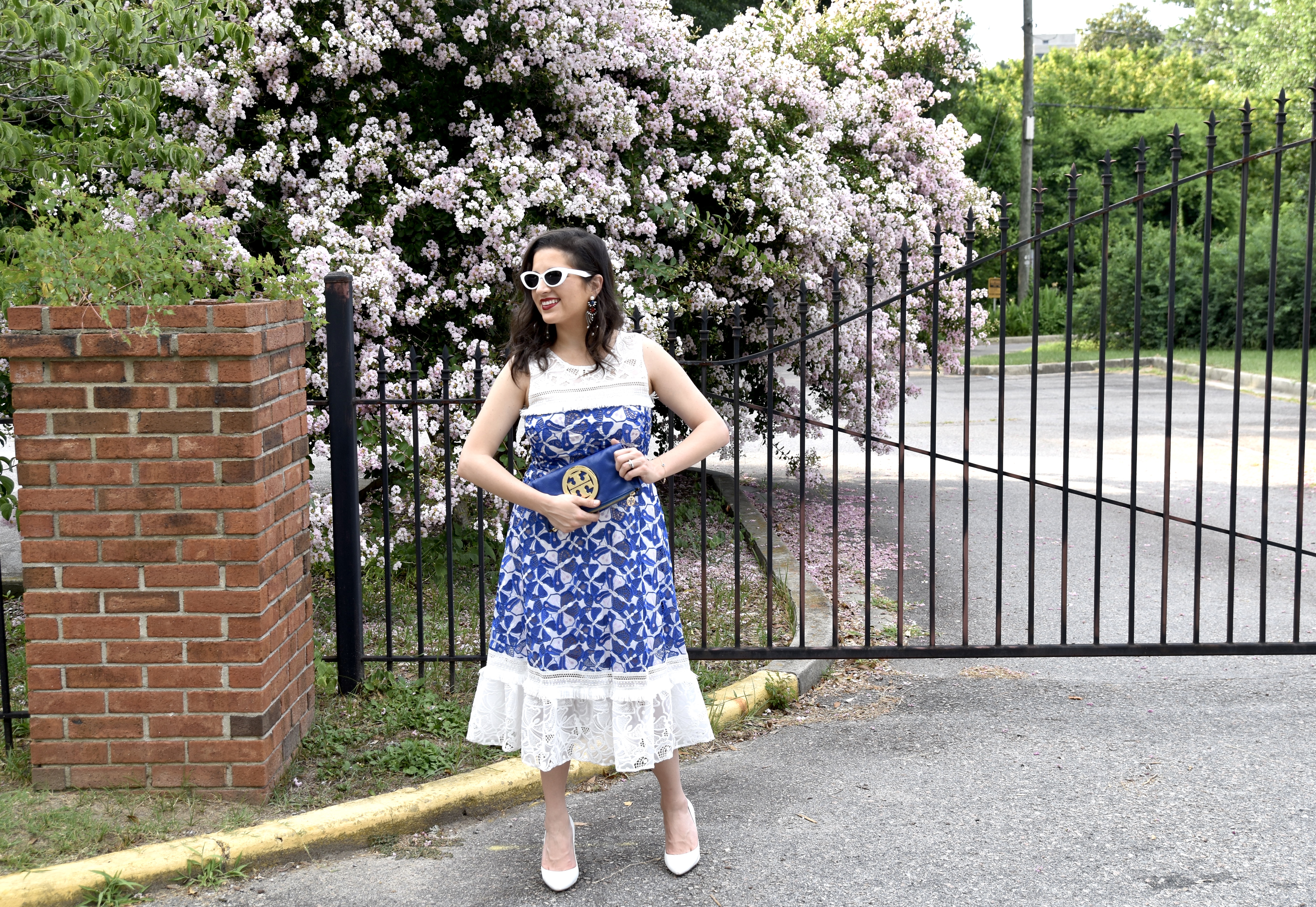 Dania dressed in Badgley Mischka and Tory Burch clutch