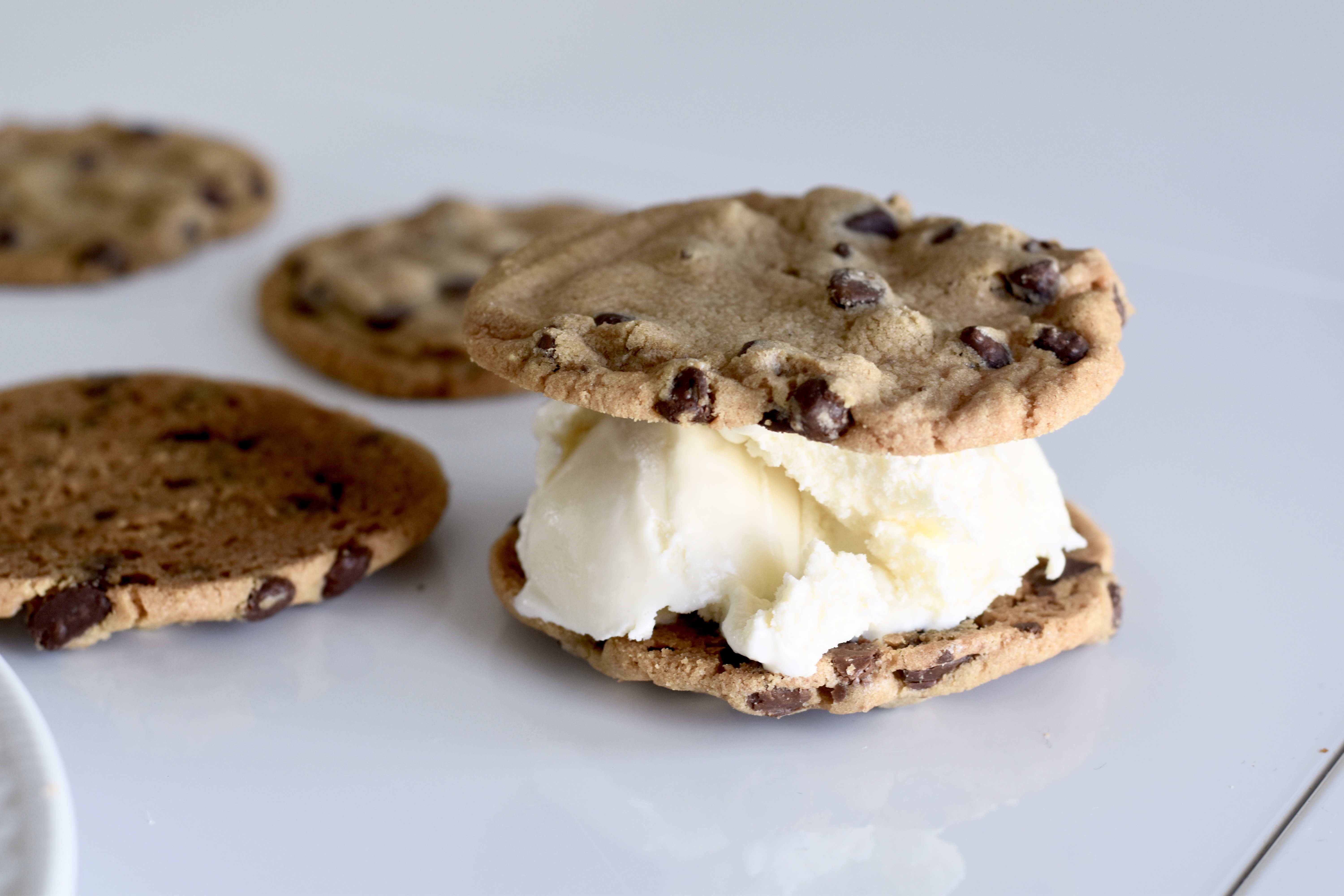 ice cream sandwiched in between two chocolate chip cookies