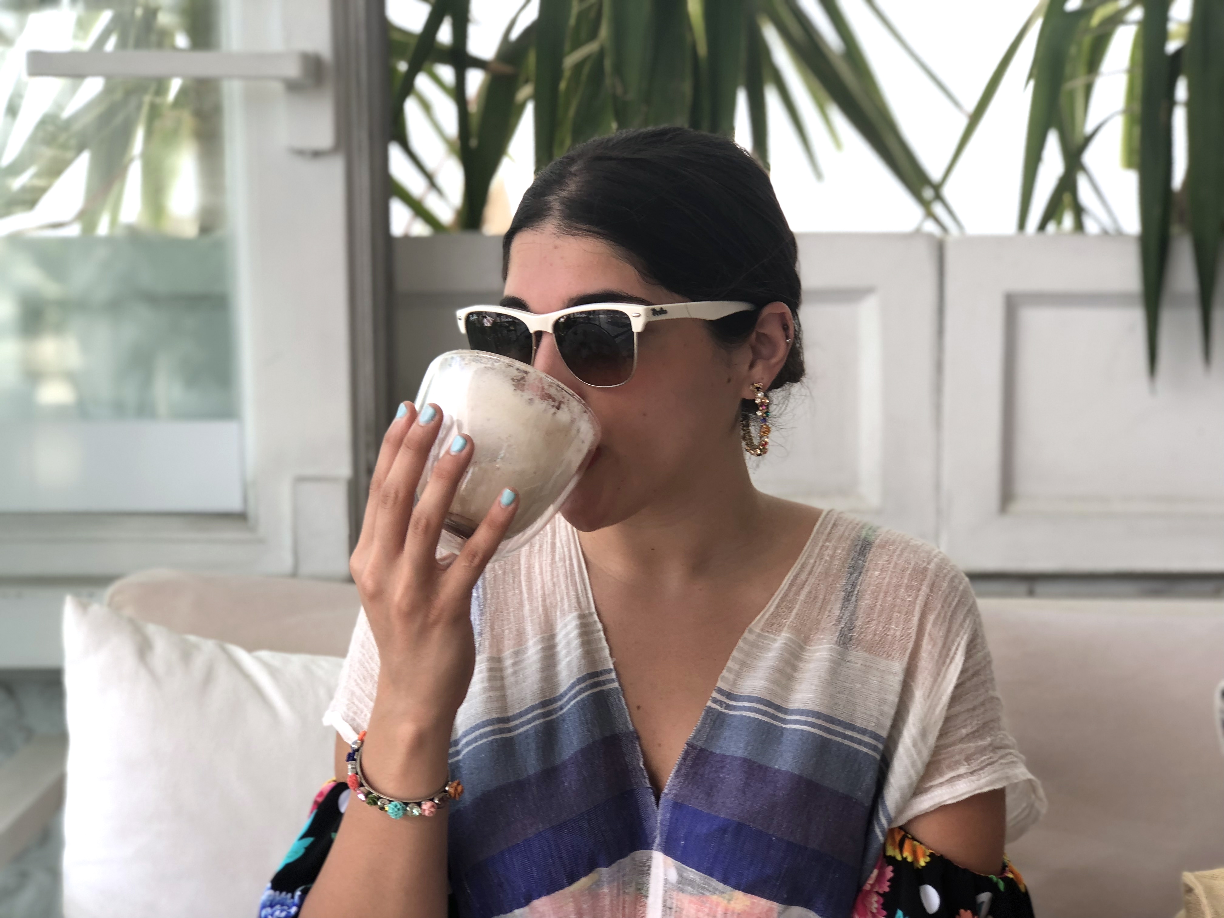 Aya sipping on chai tea latte at Bowl.