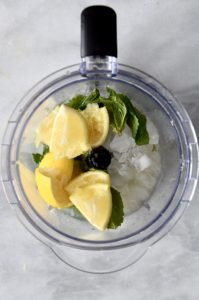 Mint and lemons in a blender with mint simple syrup