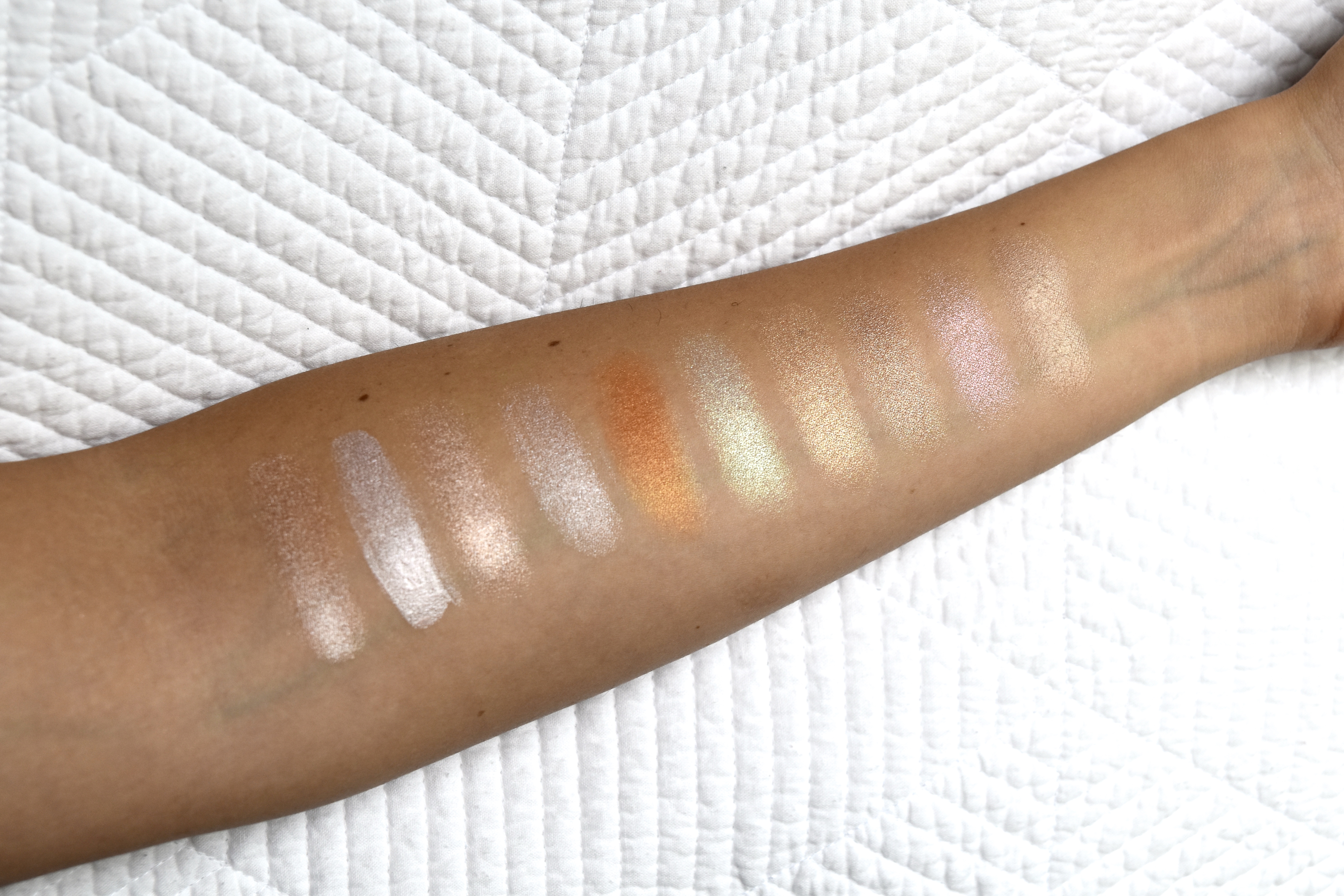 Highlighter swatches from left to right: Iconic London, Loreal, Wet and Wild, Fenty Beauty, Anastasia Moonchild, Becca Cosmetics, MAC Show gold, and Kevyn Aucoin Countour Palette