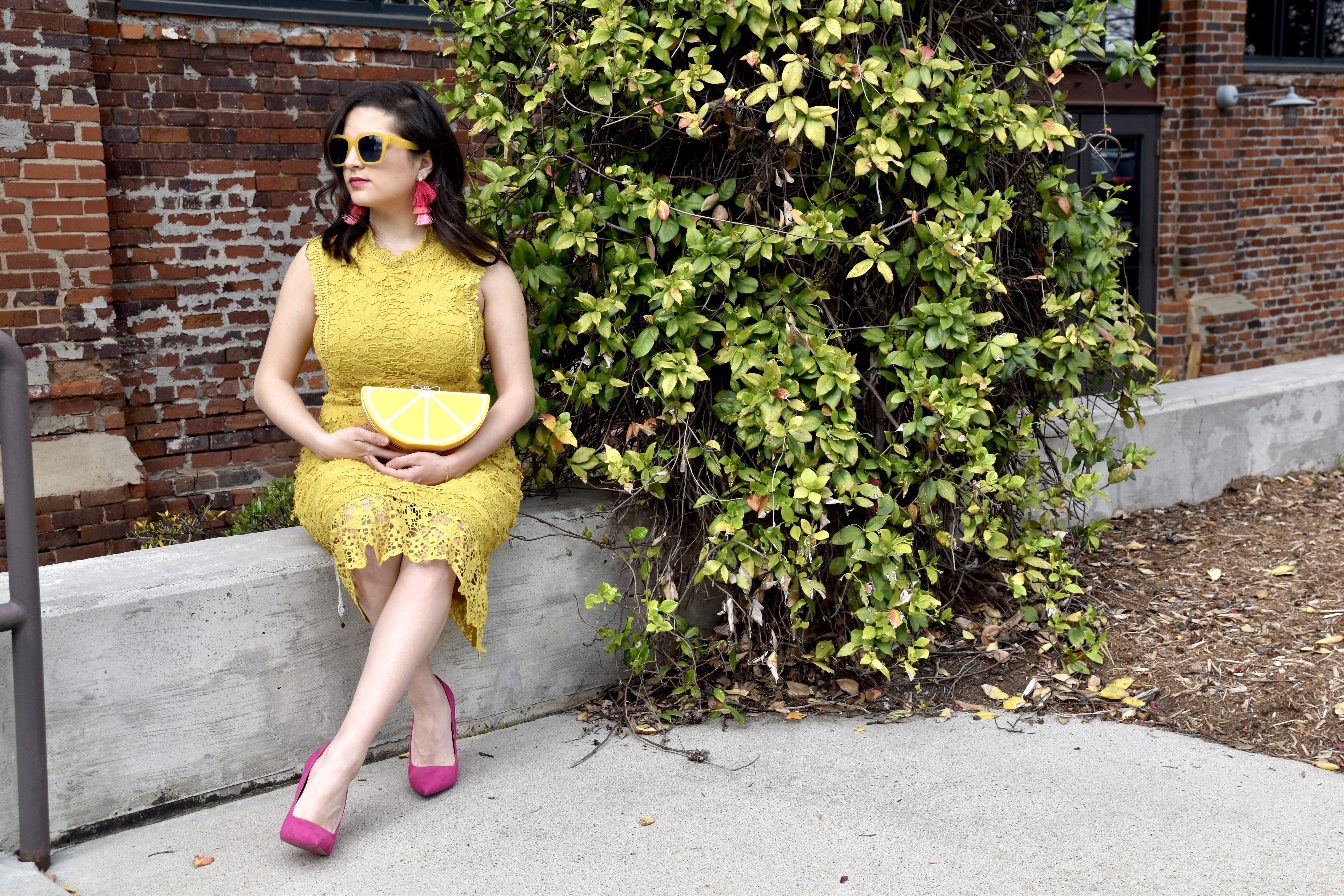 spring Boohoo yellow dress, suede pink pumps, and lemon clutch sitting