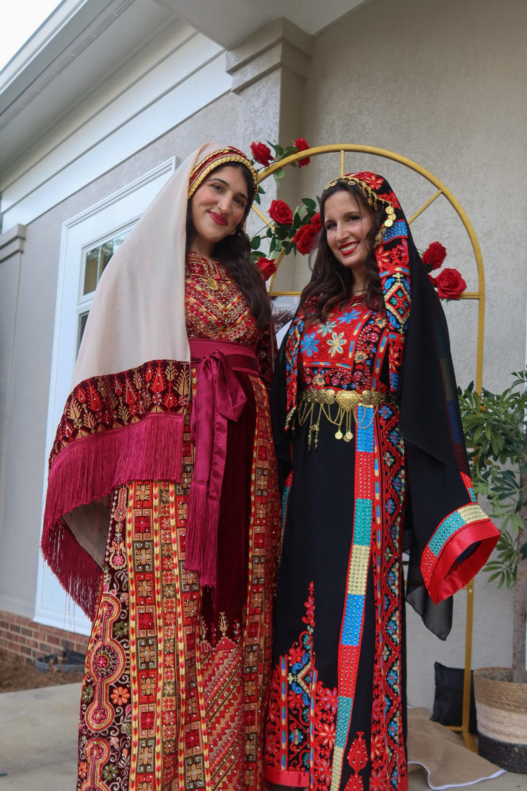 Dania and Aya in traditional embroidered Palestinian thobes